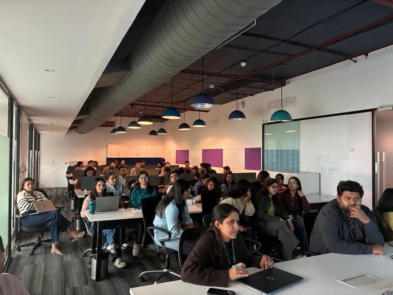The Infollion team seated at their desks in the Gurugram office.