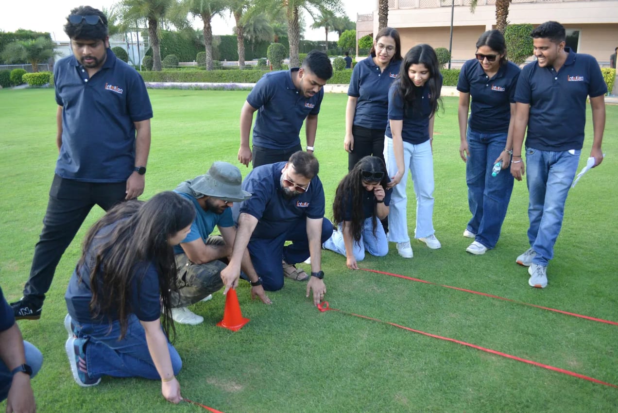 Infollion colleagues setting up an outdoor team-building activity.