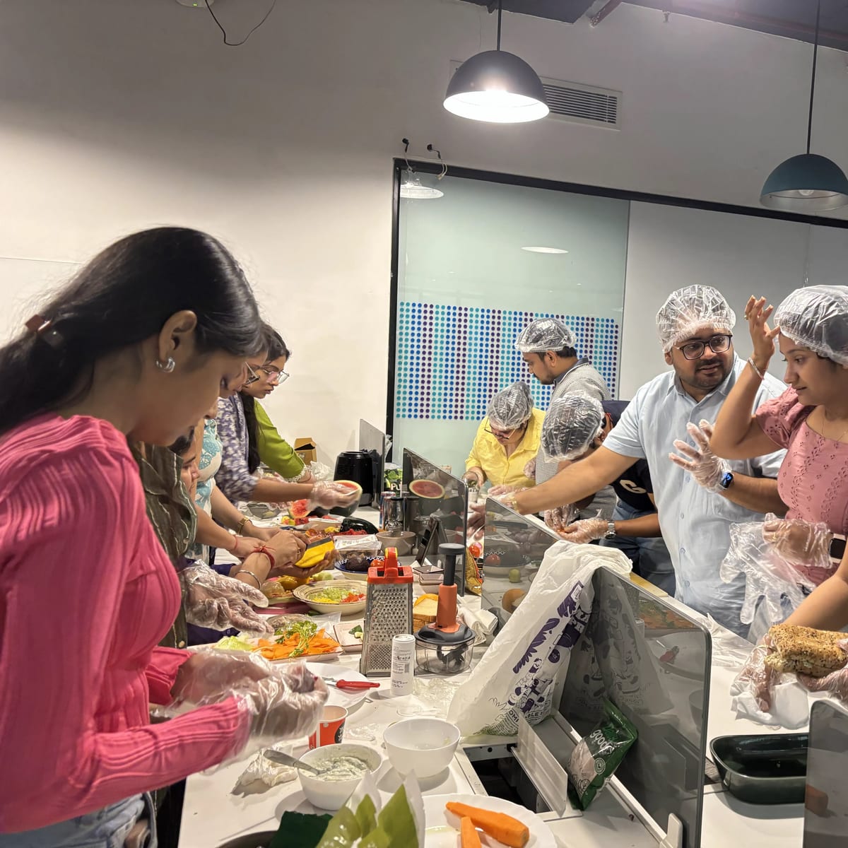 Infollion colleagues cooking together during a team offsite.