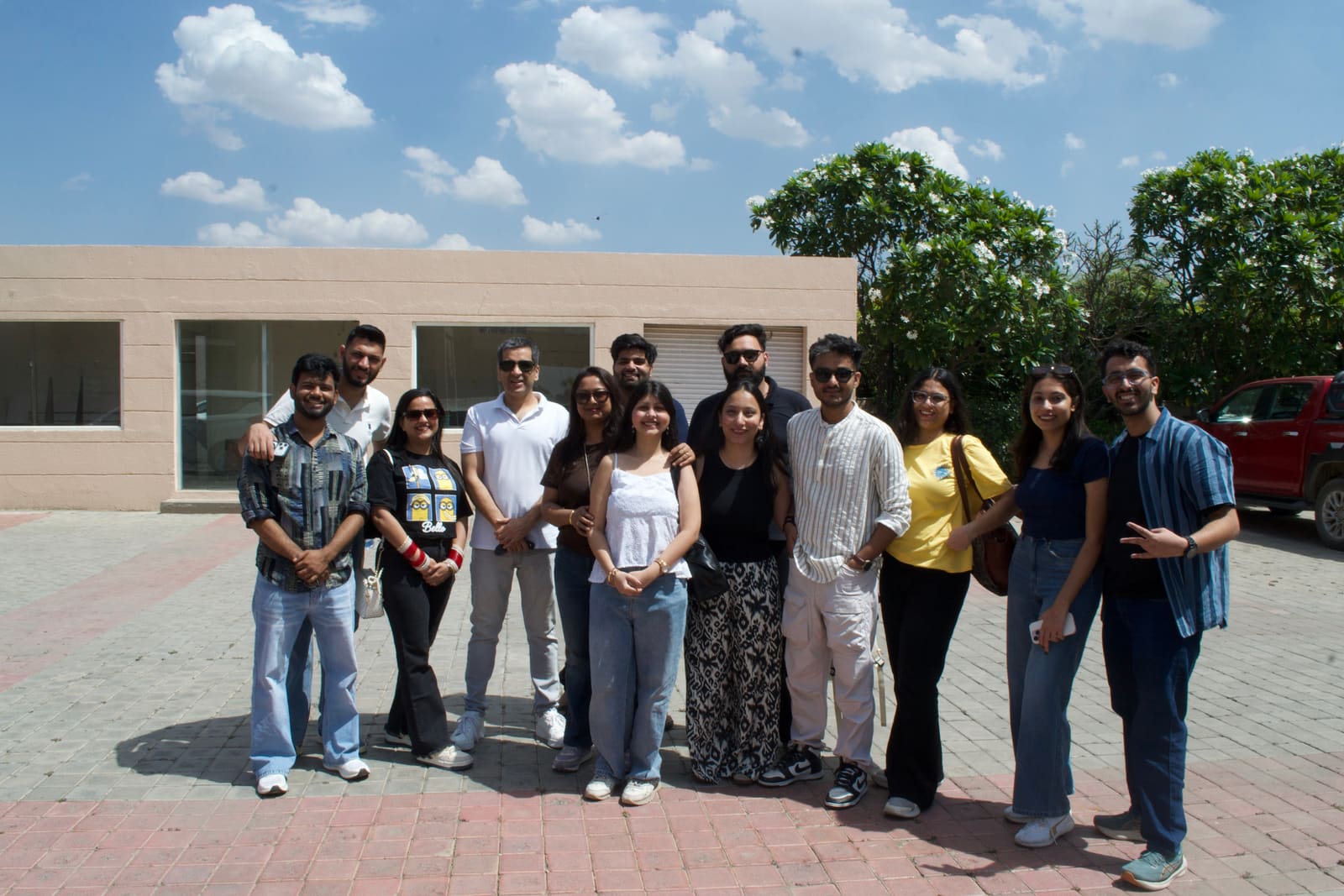 Infollion colleagues posing together outdoors during an offsite trip.